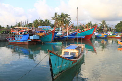 Boats moored in sea against sky