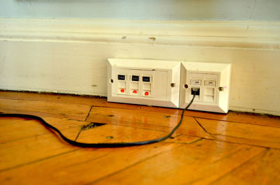 Close-up of telephone booth on hardwood floor