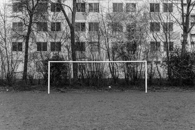 Abandoned building by trees on field