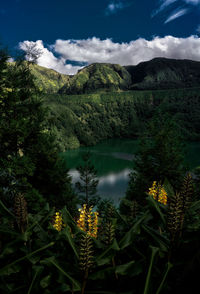 Scenic view of lake and mountains against sky