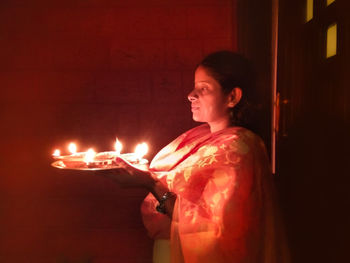 Side view of teenage girl in the dark