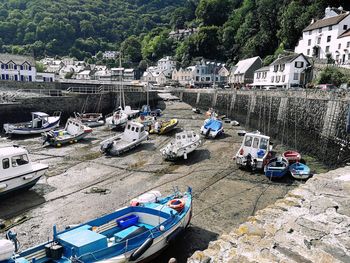 High angle view of boats moored on sea by buildings