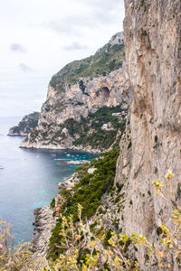 Scenic view of sea and mountains against sky