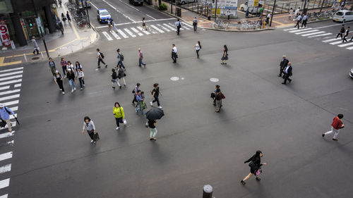 High angle view of people walking on road in city