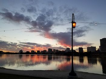 Illuminated city against sky during sunset