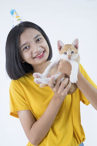 Portrait of smiling young woman with cat