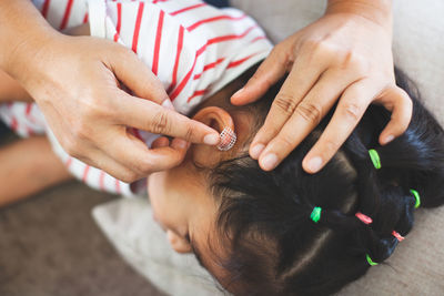 Nurse cleaning wound on girl ear