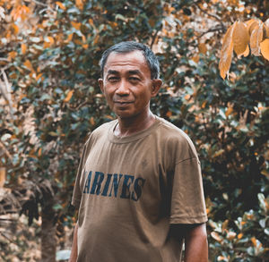 Portrait of smiling man standing outdoors