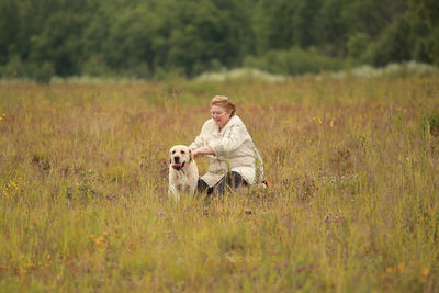 Full length of woman with dog