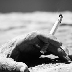 Close-up of hand holding cigarette