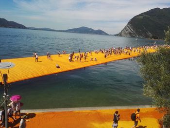 People on beach against sky
