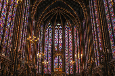 Low angle view of ornate glass window in temple