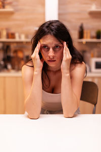 Young woman sitting on table