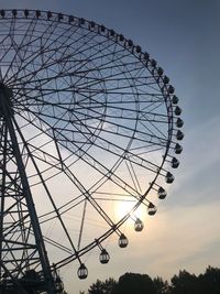 Low angle view of ferris wheel against sky