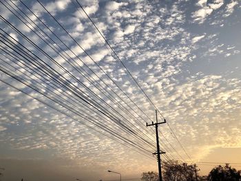 Low angle view of electricity pylon against sky