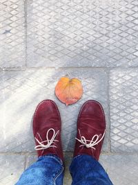 Low section of person standing on tiled floor