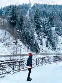Full length of woman on snow covered land