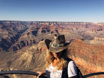 Rear view of woman wearing hat against clear sky
