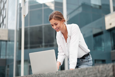 Young woman using mobile phone in office