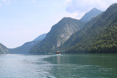 Scenic view of lake and mountains against sky