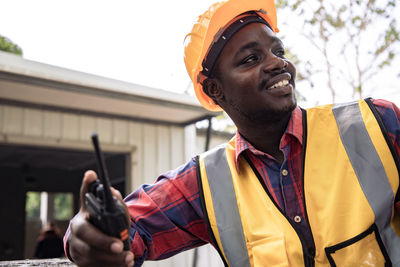 Portrait of smiling man holding camera