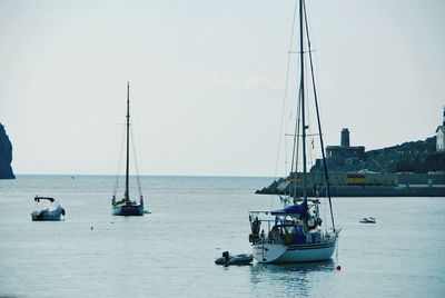 Sailboat sailing on sea against clear sky