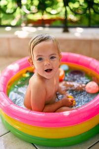 Portrait of cute baby boy in swimming pool