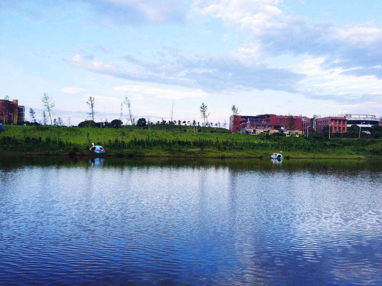 water, waterfront, building exterior, sky, architecture, built structure, river, cloud - sky, rippled, cloud, lake, nature, house, tranquility, tranquil scene, transportation, scenics, day, tree, grass