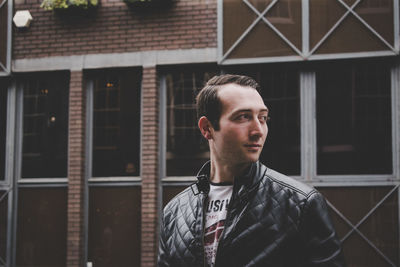 Mid adult man in front of building