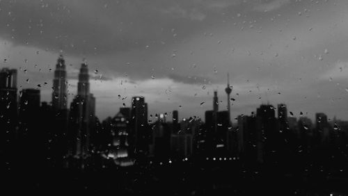 View of buildings in city during rainy season