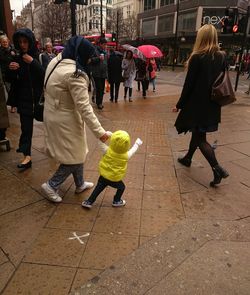 People walking on street in city