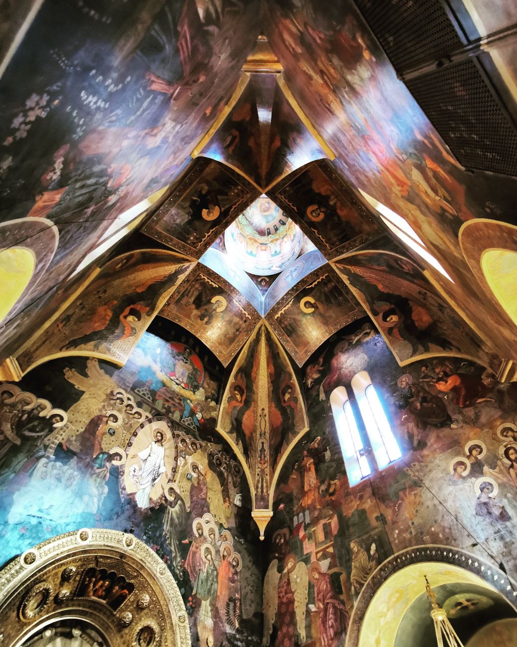 LOW ANGLE VIEW OF CLOCK ON BUILDING CEILING