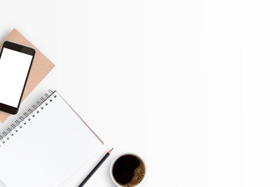 Directly above shot of book on table against white background