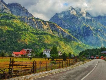 Road amidst mountains against sky