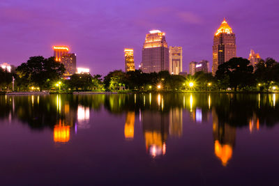 Reflection of illuminated buildings in lake at night