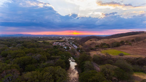 Scenic view of landscape against sky at sunset