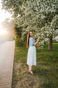Rear view of woman standing on field