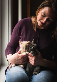 Midsection of woman with cat