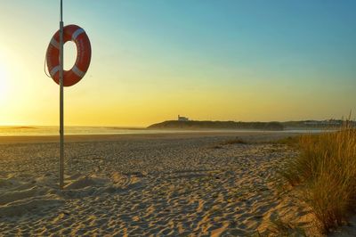 Scenic view of beach against sky during sunset