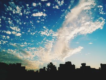 Low angle view of building against cloudy sky