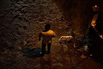 Rear view of men standing outdoors