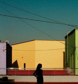 Rear view of man standing against building