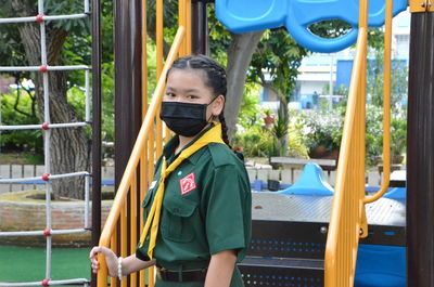 Rear view of young woman in playground