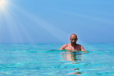 Portrait of shirtless man in swimming pool