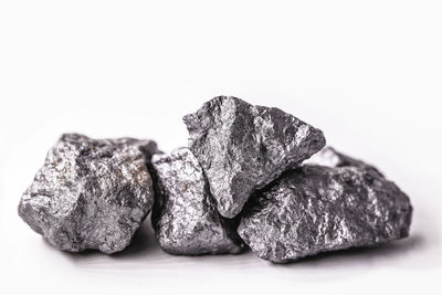 Close-up of bread on rock against white background