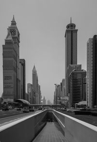 Entrance of underground walkway in city against clear sky