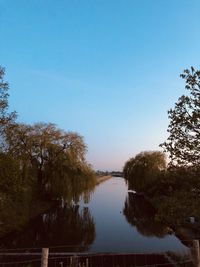 Scenic view of lake against clear blue sky