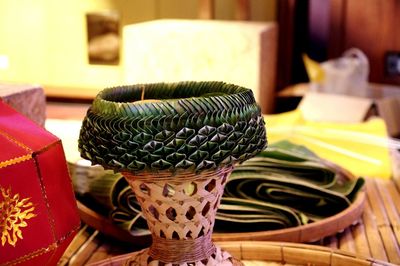 Close-up of succulent plant in basket on table at home