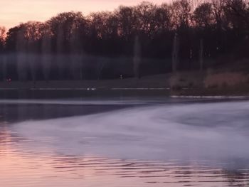 Reflection of trees in lake against sky