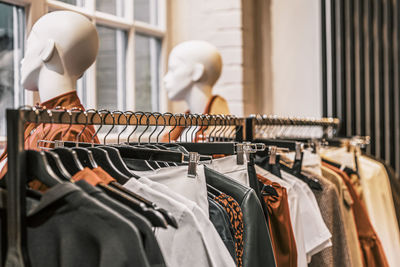 Clothes hanging in rack at store